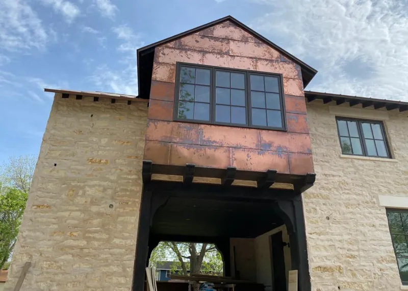 Copper metal panel facade on a stone building for Roof Repair in Clovis
